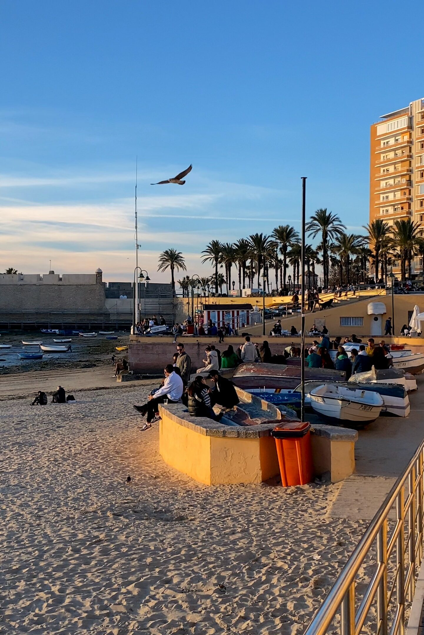 People enjoying La Caleta Beach, Cádiz, Spain